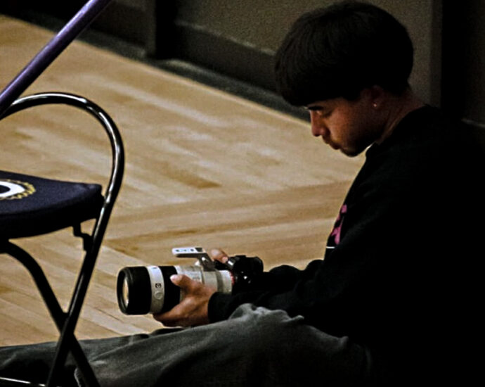 Travis takes video for Haskell athletes.