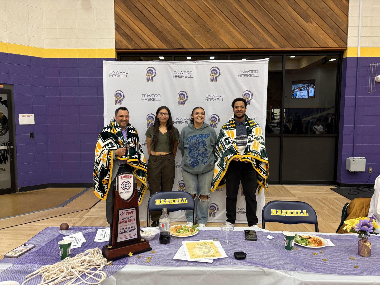 Coach Adam Strom and the Athletic Trainer were gifted blankets from Haskell Student Government Presidents. Photo courtesy of Jaden Huehl